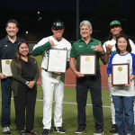 Lieutenant Governor Luke stands with Hawaii legislators and athletes on a baseball field.