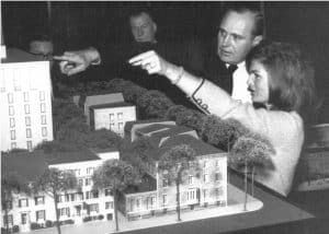 Former First Lady Jackie Kennedy and capitol architect John Warnecke pointing at miniature model of a building