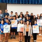 Lieutenant Governor Luke standing with middle school students from Waimea Canyon Middle School holding various posters relating to Digital Aloha Month.
