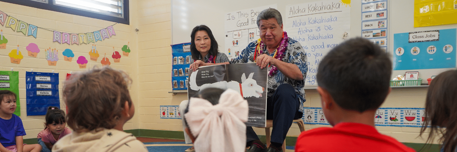 Lt. Gov. Sylvia Luke with a legislator holding a book sitting in front of pre-K students in a Ready Keiki classroom.